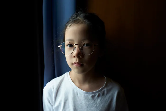 A young person looking to camera