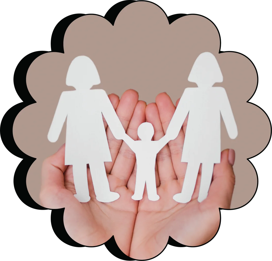 Hands holding a paper cut-out of a family