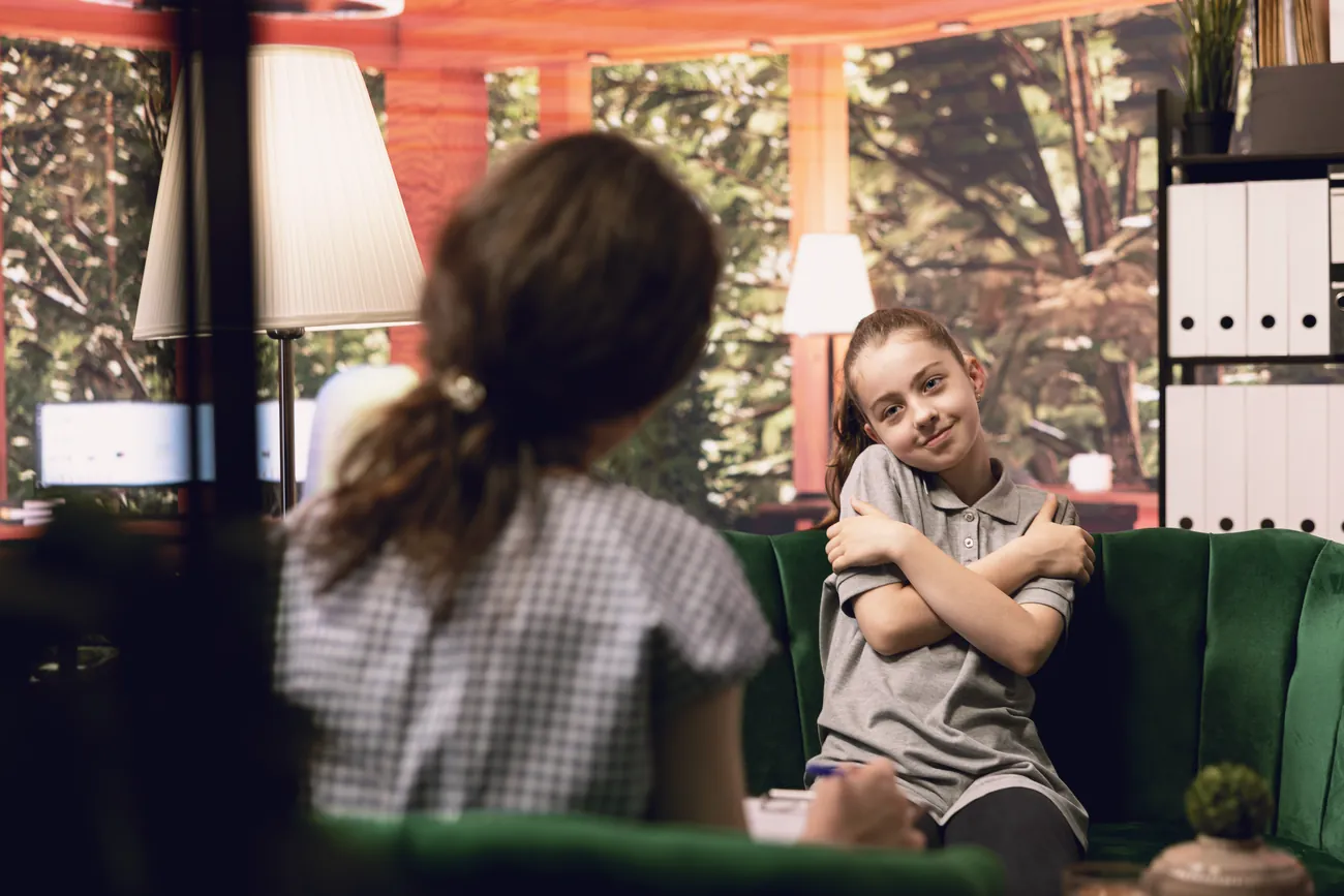 A teenage girl smiling during a therapy session