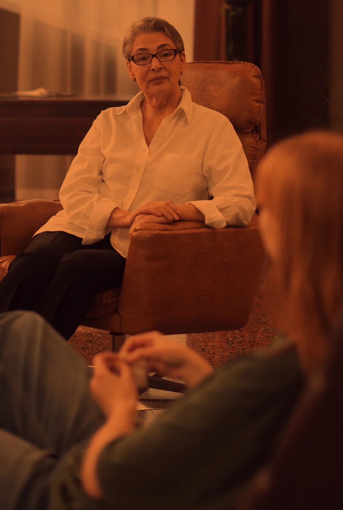 A therapist listening to a client in her office