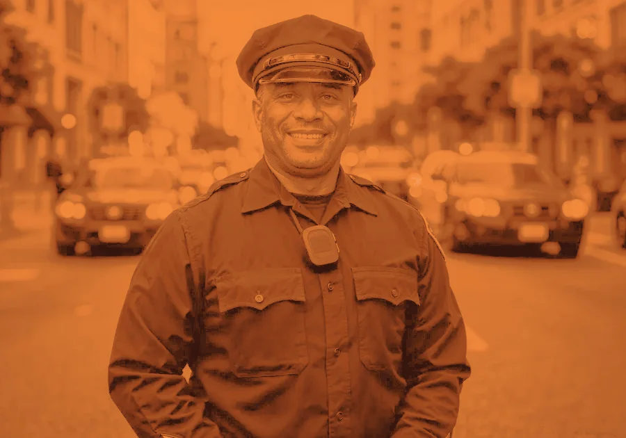 A police officer smiling on a city street